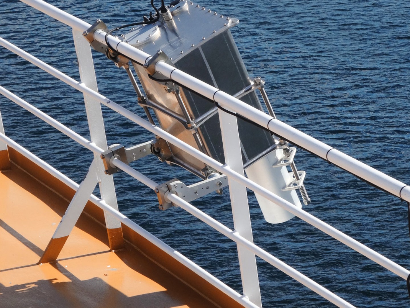 Ocean Visuals sensor mounted on the railing of a marine vessel.