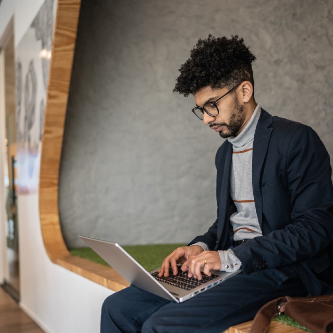 Man searches for company name on laptop.