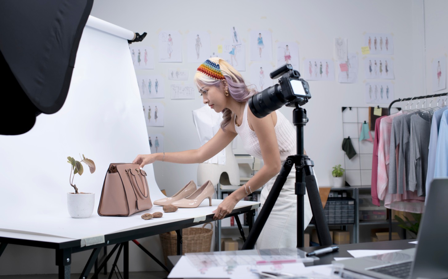 Designer takes photos of his products for marketing.